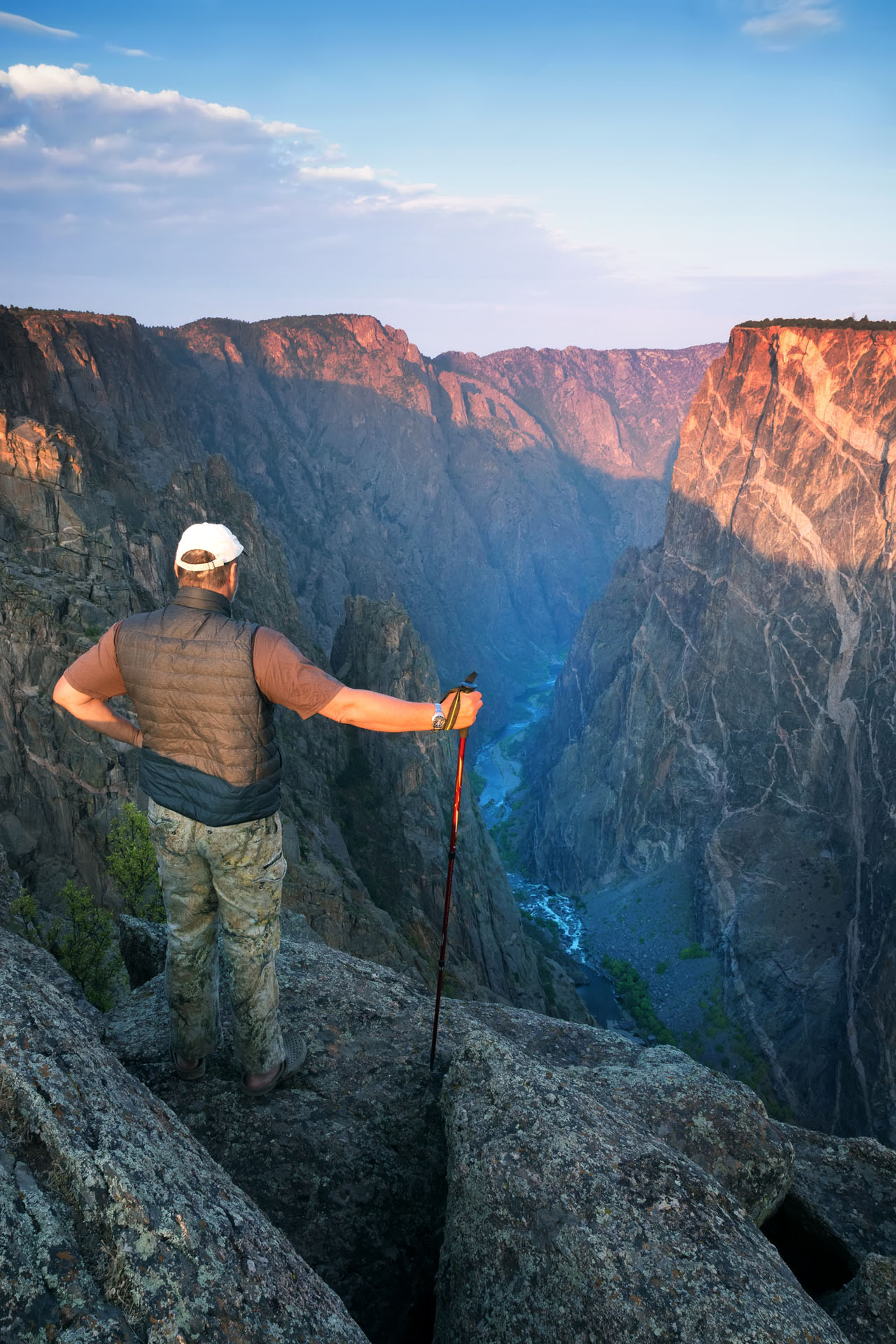 Black_Canyon_of_the_Gunnison-A man stands on the edge of the cliff and looks down. Painted Wall View,_1185291565
