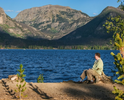 Rocky Mountain Mature Man Siting On The Shore Of Grand Lake