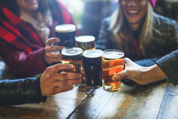woman, interacting, with, a, driver, outside Aspire Tours Group Cheers Beer