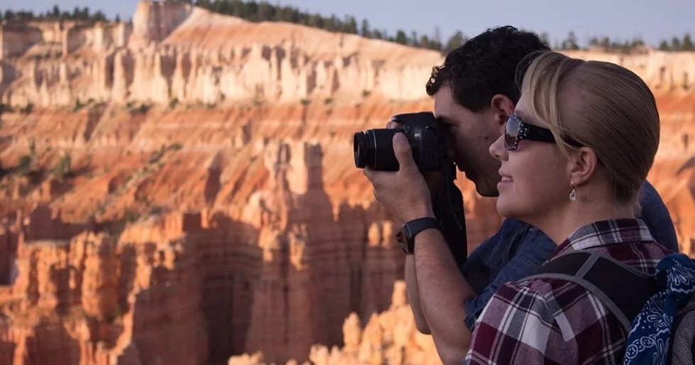 Two people taking a photo near rock formations. Desert Solitude  Day Bryce Canyon Capitol Reef Goblin Valley Photography Landscape Tourism