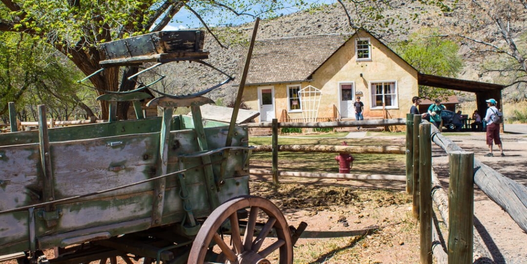 Historic house with rustic wagon outside Desert Solitude Day Bryce Canyon Capitol Reef Goblin Valley Wagon Farmhouse Fence