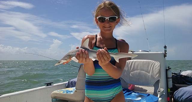 a, proud, young, angler, holding, her, catch Everglades Boattours A Proud Young Angler Holding