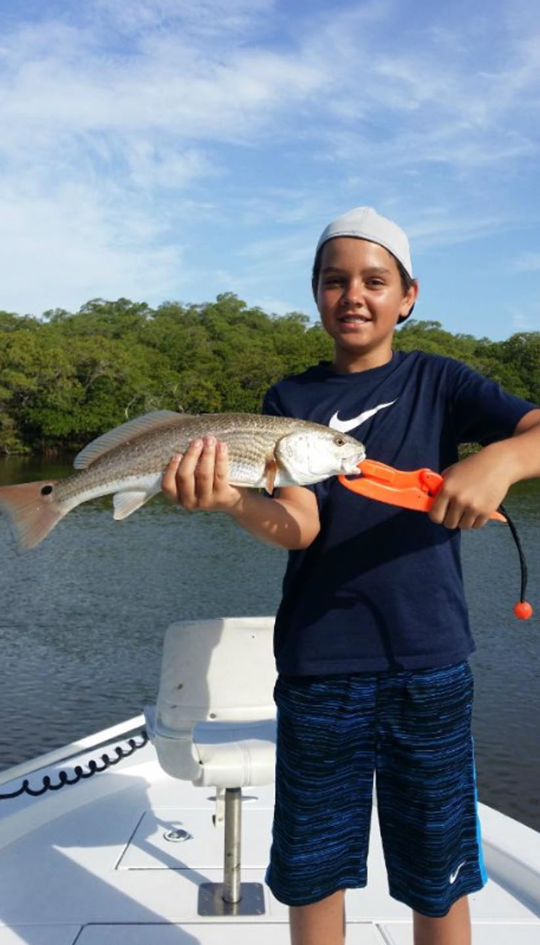 evergladescityfishingcharters-a-woman-smiling-with-her Evergladescityfishingcharters A Woman Smiling With Her