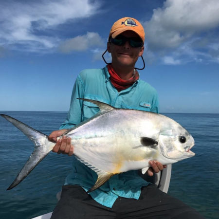 Evergladescityfishingcharters Angler Holding Silver Fish Ocean Background