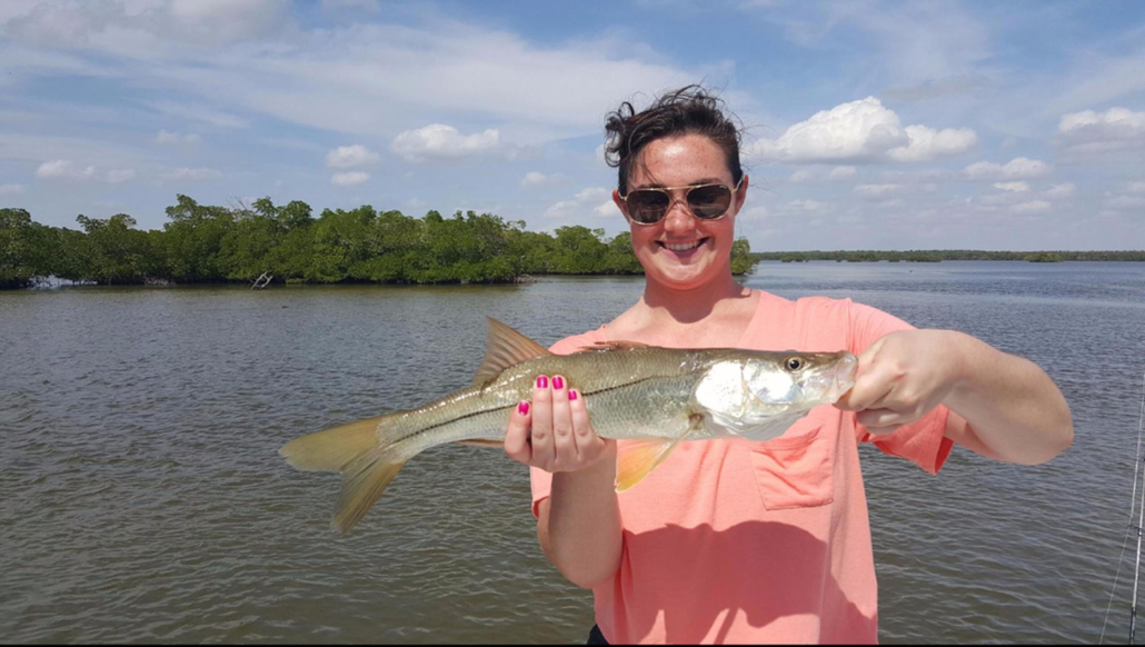 evergladescityfishingcharters_woman-holding-fish-everglades Evergladescityfishingcharters Woman Holding Fish Everglades