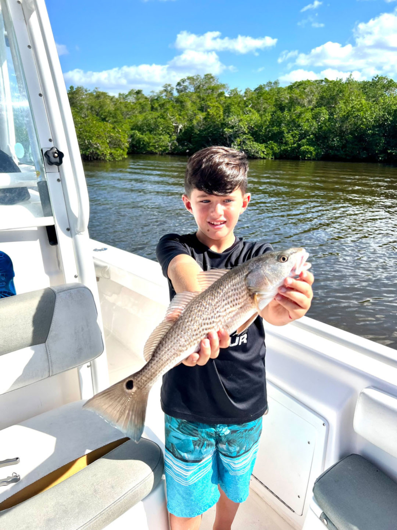 see-manatees_boy-holding-fish-everglades See Manatees Boy Holding Fish Everglades