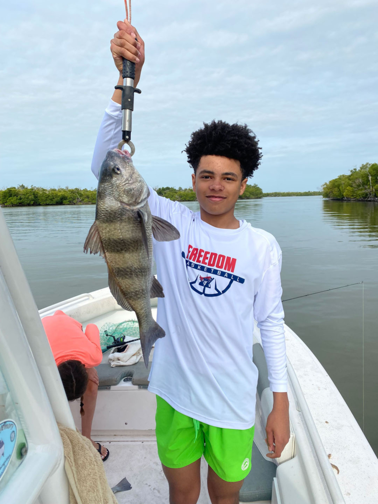 see-manatees_young-fisherman-holding-catch-everglades See Manatees Young Fisherman Holding Catch Everglades