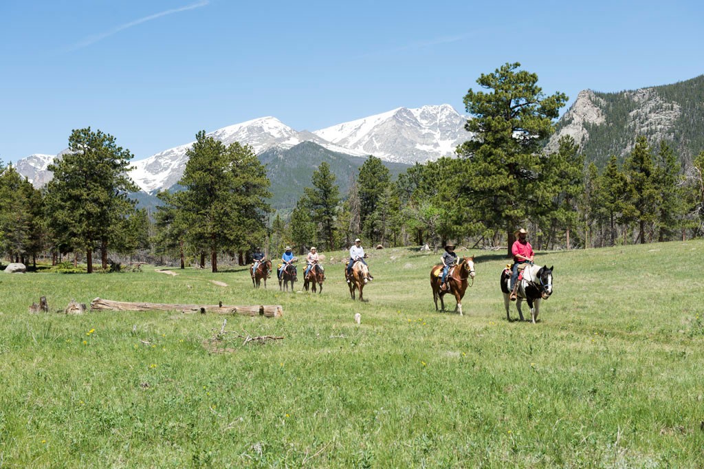 a, group, horseback, riding, in, scenic, valley Skhorses A Group Horseback Riding In