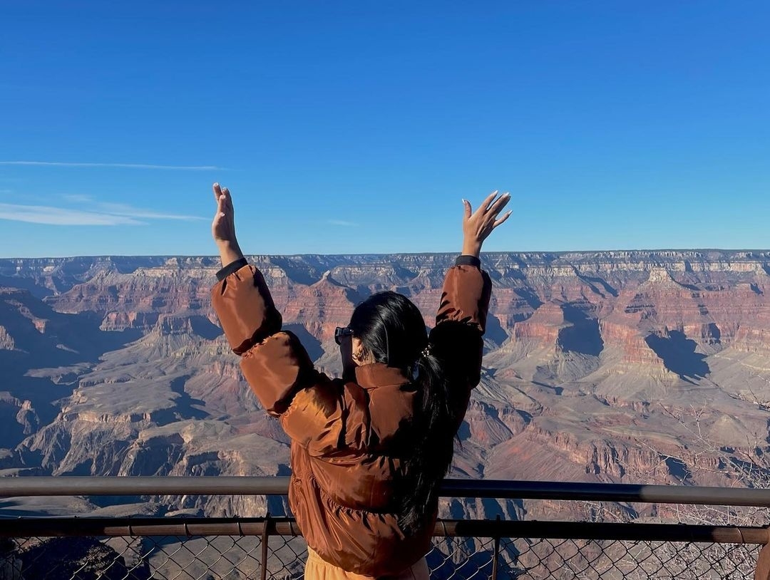 tealwheeltours-woman-raising-her-arms-by-canyon Tealwheeltours Woman Raising Her Arms By Canyon