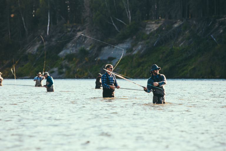 Several fishermen wade in the river casting their lines. Tetontroutfitters Fishermen Snake River Wyoming