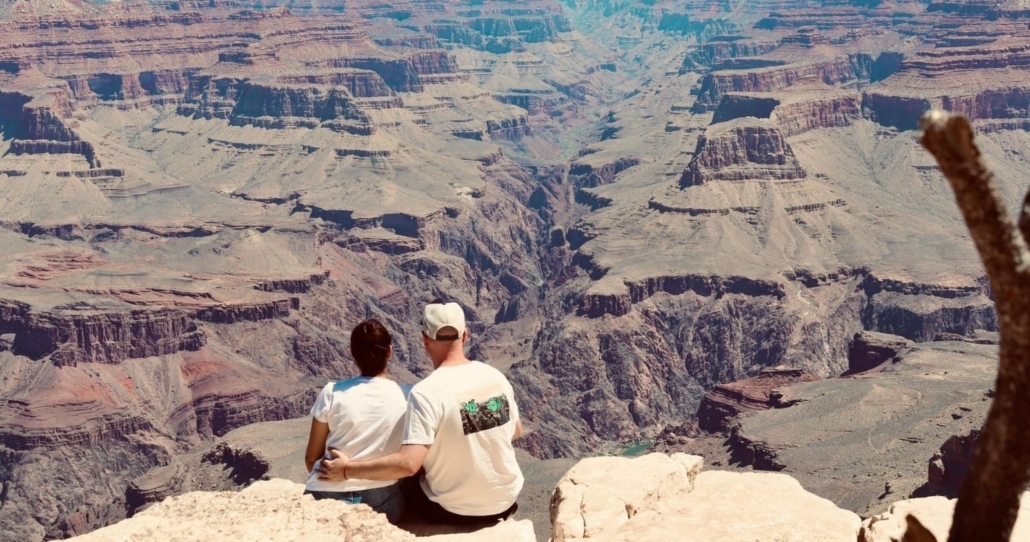 couple, sitting, on, the, edge, of, grand, canyon Topcanyontours Couple Sitting On The Edge