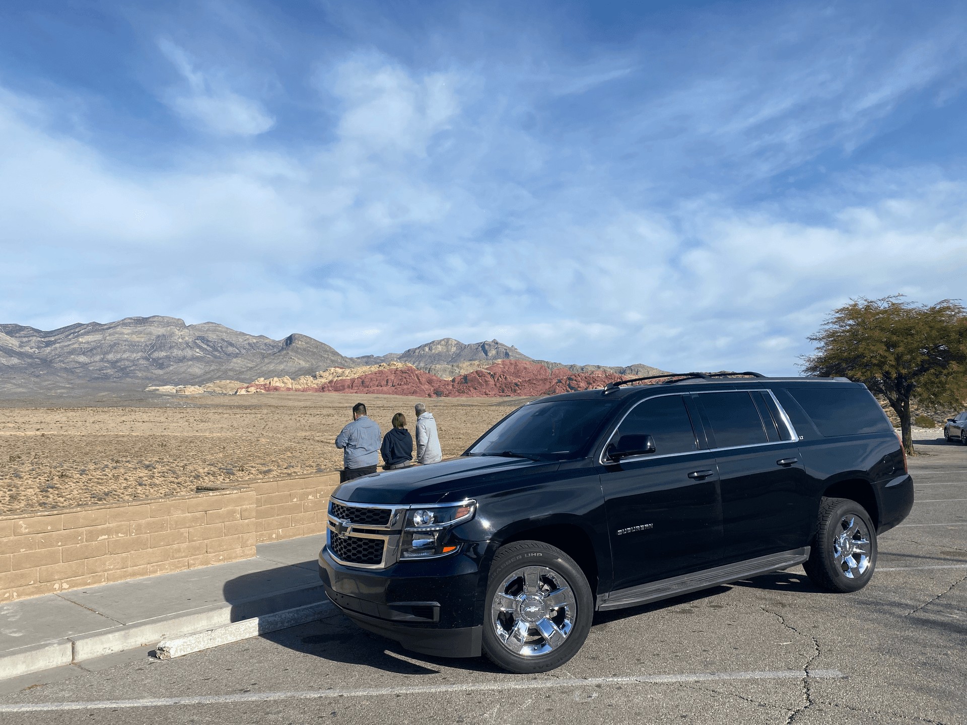a, black, suv, parked, with, scenic, mountains, in, the, background Vegastoursandrides A Black Suv Parked With