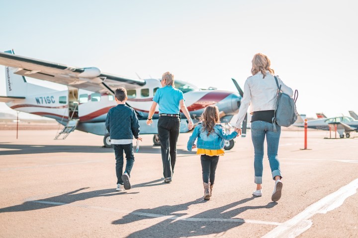 a, family, walks, towards, small, airplane, ready, for, an, adventure Westwindairservice A Family Walks Towards Small