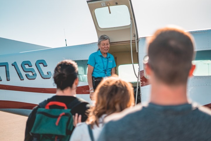 a, pilot, greets, passengers, at, small, aircraft Westwindairservice A Pilot Greets Passengers At