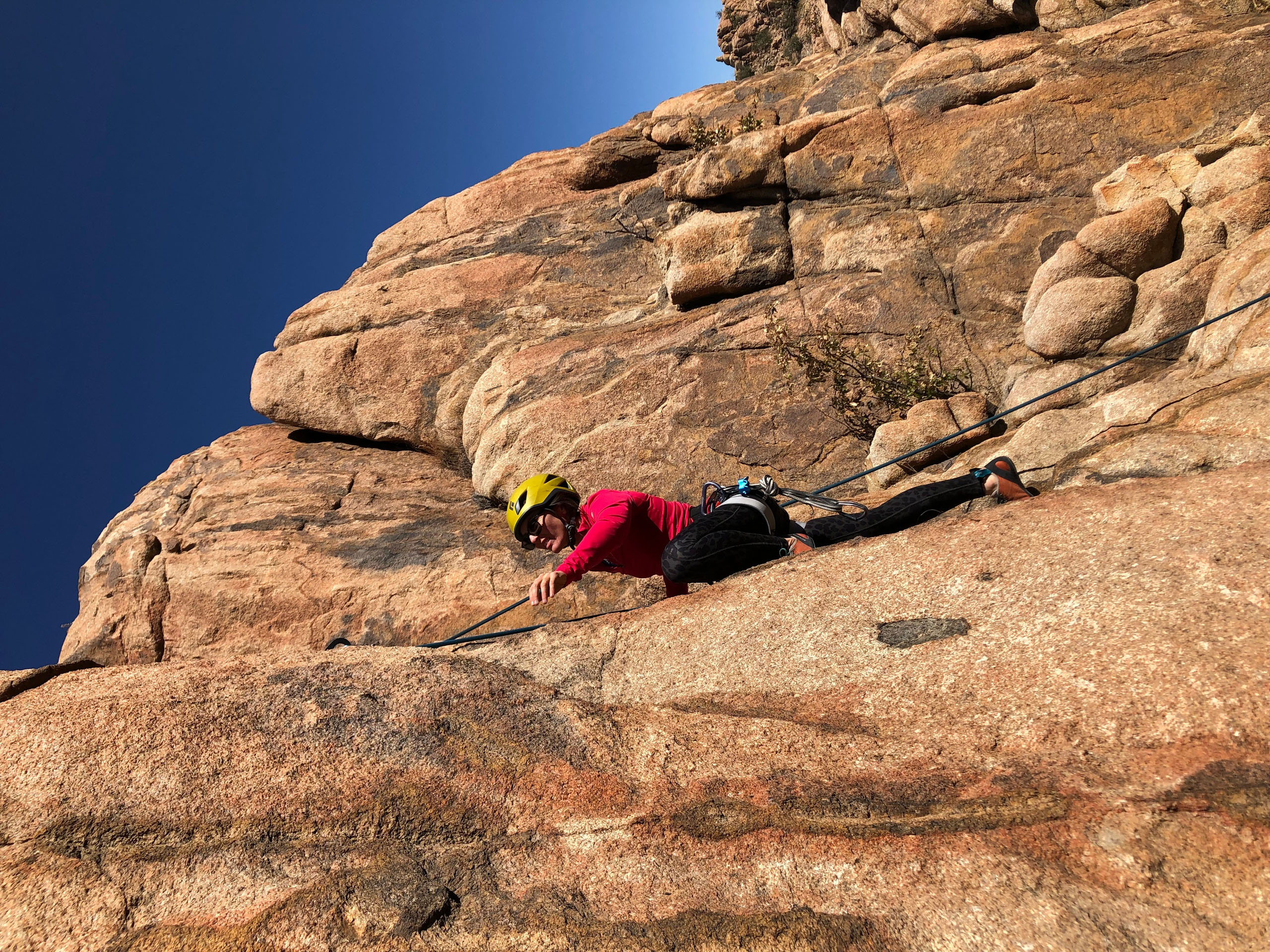 climbingguidesarizona_prescott-rock-climbing-rock-climber-yellow-helmet-red-shirt