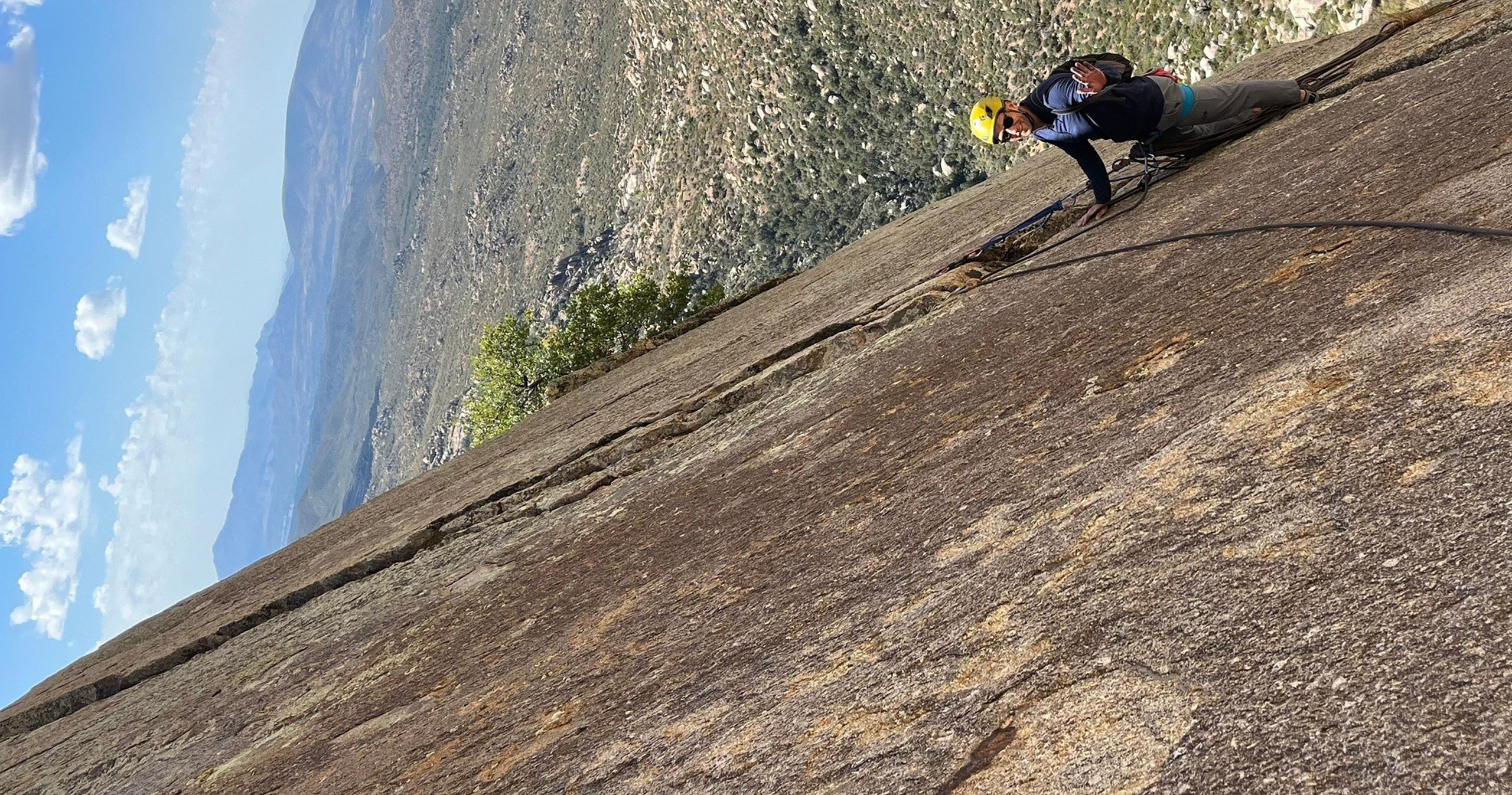 climbingguidesarizona_prescott-rock-climbing-rock-climber-yellow-helmet-sunny-day