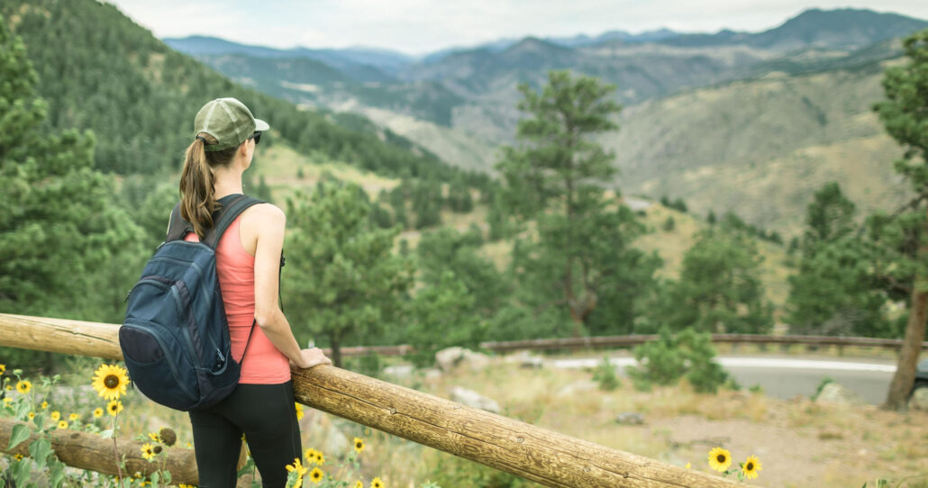 explorerdenvertours_denver-foothills-tour-hiker-sunflowers-mountain-view