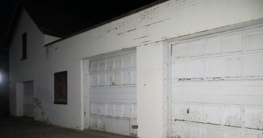 fortcollinstours_the-fort-collins-ghost-tour-white-brick-garage-doors-night