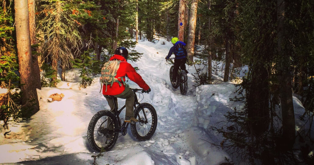 frontrangerideguides_half-day-winter-fat-bike-tour-fat-bikers-snowy-forest-trail